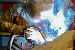 A BAE Systems welder completes a precise weld.