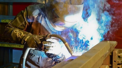 A BAE Systems welder completes a precise weld.