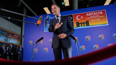NATO Secretary General Mark Rutte talks to journalists as he arrives for NATO's informal meeting of foreign ministers in Antalya, southern Turkey, Thursday, May 15, 2025.