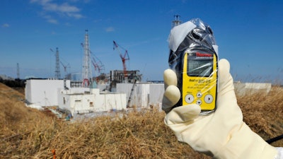 A Thermo Scientific radiation monitor indicates 131.00 mSv per hour near Unit 3 and 4 reactor buildings at Tokyo Electric Power Co.,'s tsunami-crippled Fukushima Dai-ichi nuclear power station in Okuma, Fukushima prefecture, northeastern Japan, Tuesday, Feb. 28, 2012.