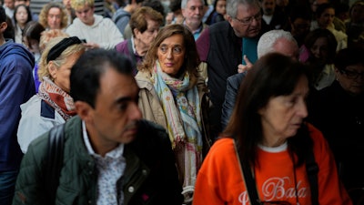Travelers wait on the platforms for news about their delayed trains at the Madrid train station, Spain, Monday, May 5, 2025.