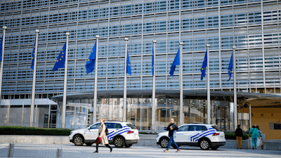 Police cars stand outside EU headquarters in Brussels, Sept. 30, 2022.
