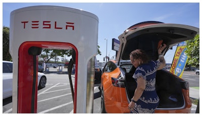 Janelle Lowe prepares to charge her electric vehicle at a charging station Thursday, May 22, 2025, in Long Beach, Calif.
