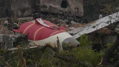 Parts of an Air India plane that crashed on Thursday are seen on top of a building in Ahmedabad, India, Friday, June 13, 2025.