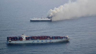 In this photo provided by the U.S. Coast Guard, smoke rises from cargo vessel Morning Midas approximately 300 miles south of Adak, Alaska, June 3, 2025.