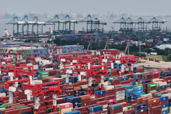 Trucks loaded with container move through a container terminal port in Shanghai, China Monday, June 9, 2025.