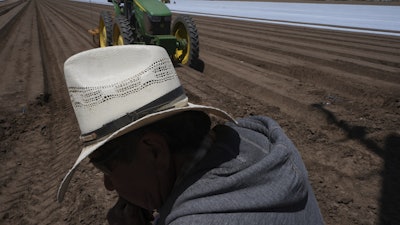 Farm workers plow the land for a strawberry field in Oxnard, Calif., on Wednesday, June 18, 2025.