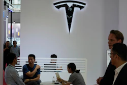 Visitors at the Tesla booth during the 3rd China International Supply Chain Expo at the China International Exhibition Center, in Beijing, China, Friday, July 18, 2025.