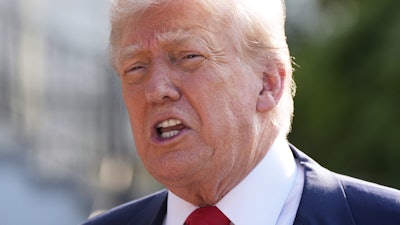 President Donald Trump speaks with reporters before departing on Marine One from the South Lawn of the White House, Friday, July 25, 2025, in Washington. The President is traveling to Scotland.