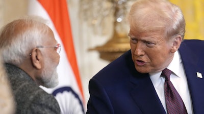 President Donald Trump, right, speaks with India's Prime Minister Narendra Modi during a news conference in the East Room of the White House, Feb. 13, 2025, in Washington.