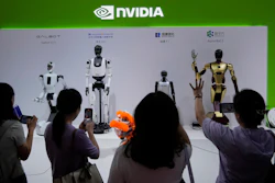 Visitors give commands to a robot at Nvidia's booth during the 3rd China International Supply Chain Expo at the China International Exhibition Center, in Beijing, China, Friday, July 18, 2025.