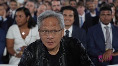 Nvidia CEO Jensen Huang arrives before President Donald Trump speaks during an AI summit at the Andrew W. Mellon Auditorium, Wednesday, July 23, 2025, in Washington.