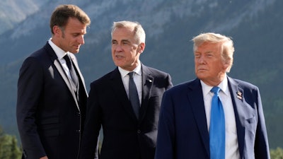 From left, French President Emmanuel Macron, Canadian Prime Minister Mark Carney and President Donald Trump arrive at the G7 Summit in Kananaskis, Alberta, June 16, 2025.