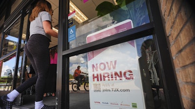 A 'now hiring' sign, July 15, 2025, Richardson, Texas.