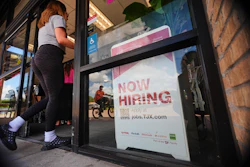 A 'now hiring' sign, July 15, 2025, Richardson, Texas.