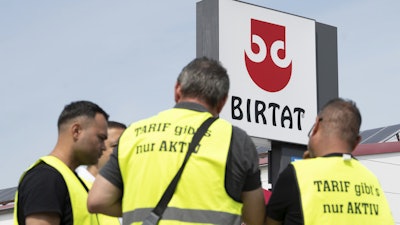 Strikers stand in front of the Birtat factory in Murr, Germany, Wednesday, Aug. 6, 2025.