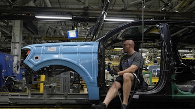 A vehicle assembly technician works on a 2025 Ford Expedition during a media tour to launch the 2025 Ford Expedition at the Ford Motor Company Kentucky Truck Plant, April 30, 2025, in Louisville, Ky.