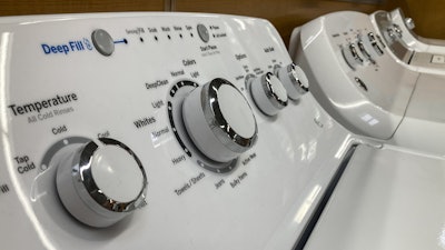 A General Electric washer sits inside a retailer, Sept. 15, 2023, in Marietta, Ga.