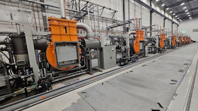 This photo provided by Noveon Magnetics, a row of specialized furnaces that are used to produce rare earth magnets sits inside the Noveon Magnetics plant in San Marcos, Texas.