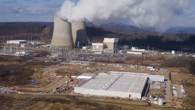 A data center owned by Amazon Web Services, front right, is under construction next to the Susquehanna nuclear power plant in Berwick, Pa., on Jan. 14, 2025.