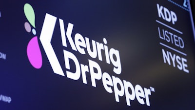 The logo for Keurig Dr. Pepper appears above a trading post on the floor of the New York Stock Exchange, July 12, 2018.