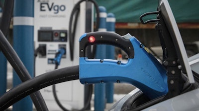 In this photo provided by VTDigger, an electric vehicle is seen plugged into a fast charger in Rutland, Vt., Feb. 17, 2022.