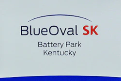 Logos for BlueOval SK and Ford are displayed on a podium during a celebration for the progress of the BlueOval SK Battery Park in Glendale, Ky., Dec. 5, 2022.