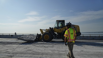 A demolition crew removes a slab of concrete from the remaining portions of the Francis Scott Key Bridge, Wednesday, July 30, 2025, in Baltimore.