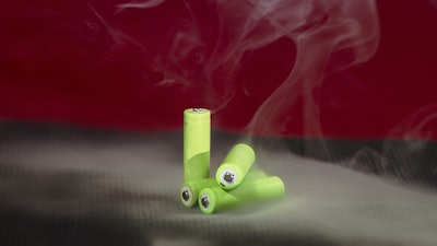 A stock image of green batteries smoking.