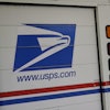 U.S. Postal Service delivery vehicles are parked outside a post office in Boys Town, Neb., Aug. 18, 2020.