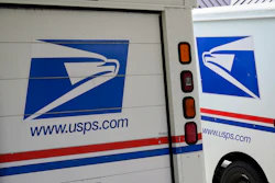 U.S. Postal Service delivery vehicles are parked outside a post office in Boys Town, Neb., Aug. 18, 2020.
