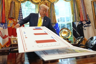 President Donald Trump holds charts in the Oval Office, Aug. 7, 2025.