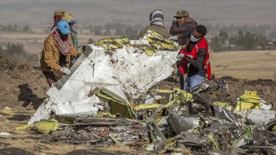 Workers recover debris at the scene of an Ethiopian Airlines Boeing Max plane crash on March 11, 2019, outside of Addis Ababa, Ethiopia.