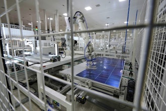 A robot places solar cells on a glass panel at a ReNew manufacturing plant on the outskirts of Jaipur, India, Thursday, Aug. 21, 2025.
