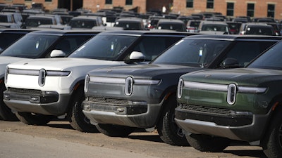 A long line of unsold 2024 R1S electric utility vehicles sits at a Rivian service center Nov. 26, 2024, in east Denver.