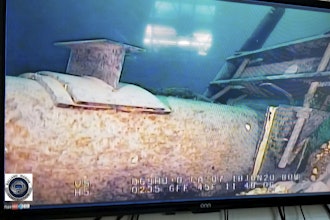 This photo provided by the Michigan Department of Environment, Great Lakes, and Energy in June 2020 shows damage to anchor support EP-17-1 on the east leg of the Enbridge Line 5 pipeline in the Straits of Mackinac in Michigan, displayed on a television screen.