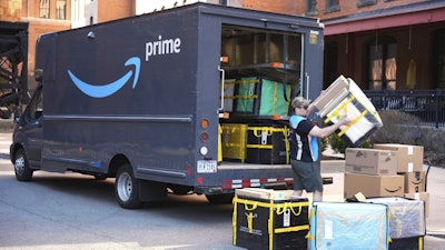An Amazon driver makes a delivery outside an apartment building in Pittsburgh, March 10, 2025.
