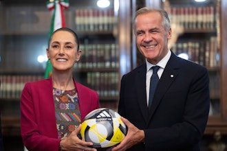 Canada's Prime Minister Mark Carney, right, presents Mexican President Claudia Sheinbaum with an official World Cup soccer ball before they meet at the Palacio National in Mexico City, Thursday, Sep 18, 2025.