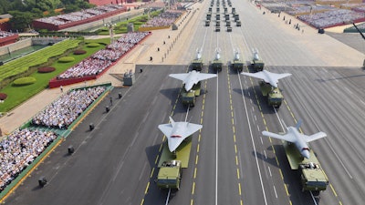 In this photo released by Xinhua News Agency, drones and other armament formations pass during the military parade to commemorate the 80th anniversary of the end of World War II held in front of Tiananmen Gate in Beijing, Wednesday, Sept. 3, 2025.