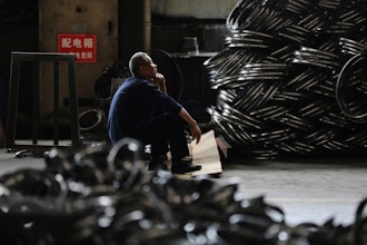 A worker takes a rest at a factory making steel bike rims for export to U.S., in Hangzhou in east China's Zhejiang province, on Friday, April 11, 2025.