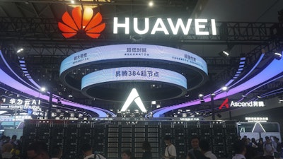 Visitors pass by the Huawei Atlas 900 A3 SuperPoD exhibited at the World Artificial Intelligence Conference in Shanghai, China, July 28, 2025.