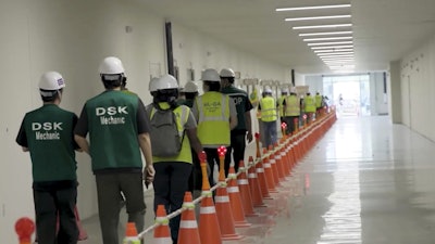 This image from video provided by U.S. Immigration and Customs Enforcement via DVIDS shows manufacturing plant employees being escorted outside the Hyundai Motor Group’s electric vehicle plant, Thursday, Sept. 4, 2025, in Ellabell, Ga.