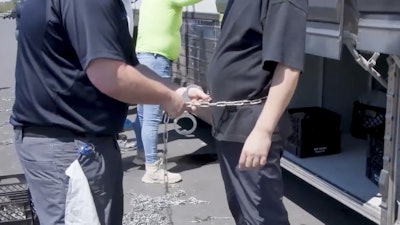 This image from video provided by U.S. Immigration and Customs Enforcement via DVIDS shows a person being handcuffed at the Hyundai Motor Group’s electric vehicle plant, Thursday, Sept. 4, 2025, in Ellabell, Ga.