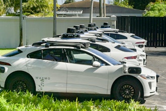 Row of self-hail autonomous driving taxi cabs owned and operated by Waymo.