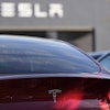 A Tesla model Y and other Telsla vehicles sit at a dealership, Wednesday, March 19, 2025, in Kennesaw, Ga.
