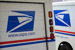 U.S. Postal Service delivery vehicles are parked outside a post office in Boys Town, Neb., Aug. 18, 2020.