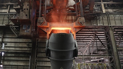 A giant ladle glows red after pouring molten iron in to a vessel inside the basic oxygen furnace as part of the processes of making steel at the U.S. Steel Granite City Works facility Thursday, June 28, 2018, in Granite City, Ill.