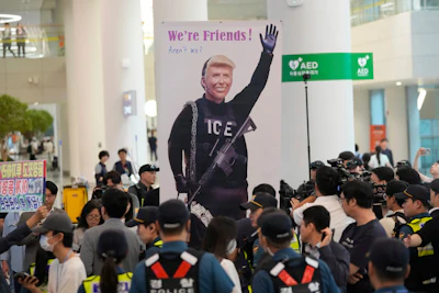 A banner depicting U.S. President Donald Trump is seen at the arrival terminal of the Incheon International Airport, in Incheon, South Korea, Friday, Sept. 12, 2025.