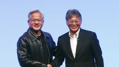Nvidia Chief Executive Jensen Huang, left, and Fujitsu Chief Executive Takahito Tokita shake hands during an announcement in Tokyo Friday, Oct. 3, 2025.