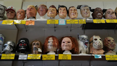 A variety of face masks line the shelves at the House of Humor costume shop in Redwood City, Calif., Thursday, Sept. 18, 2025.
